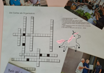Ein Arbeitsblatt über die Caritas mit Kreuzworträtsel und Bildern von Mitarbeitern bei der Arbeit.
